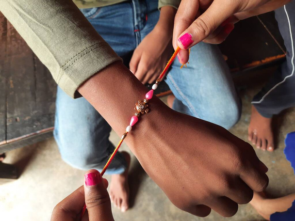Sister tying rakhi to her brother. This festival celebrated across India as selfless love or relationship between brother and sister. Indian festival Raksha Bandhan. Indian culture. - Photo, Image