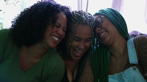Girlfriends laughing together. Three black women smiling. Real life happiness emotion - Foto, Imagen