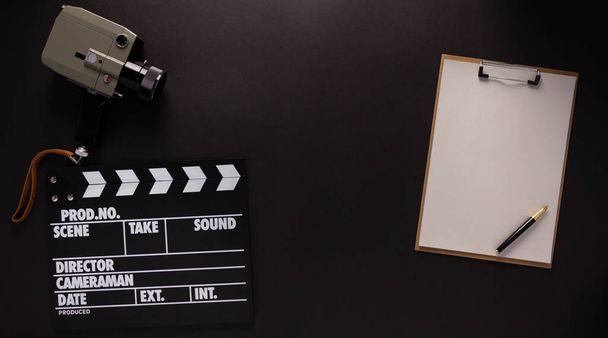 Clapboard and paper at black background texture. Movie idea concept - Foto, imagen