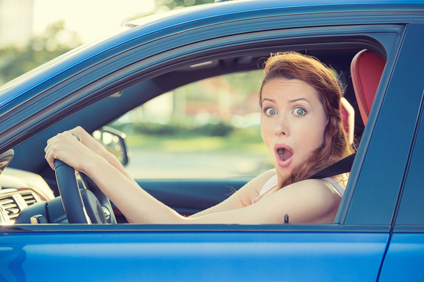 Distracted fright face of woman driving car - Fotoğraf, Görsel