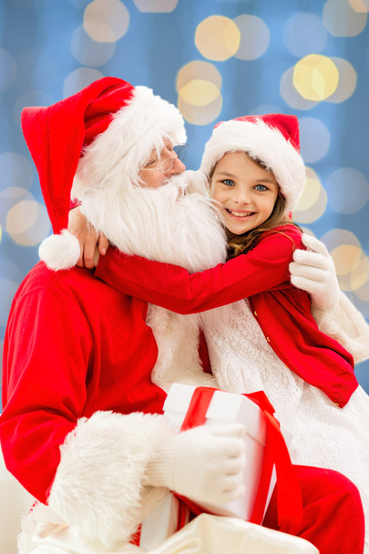 smiling little girl with santa claus - Fotó, kép