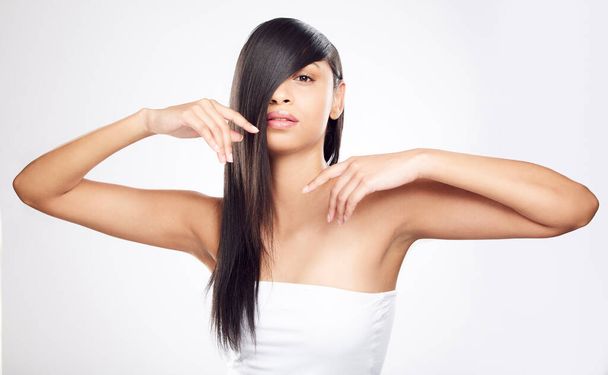 Be sleek not sly. a young woman posing against a white background with healthy looking hair - Foto, Imagem