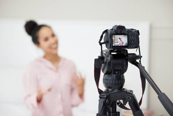 Follow me for more tips. a young woman using a camera to record a video for her blog - Foto, Imagem