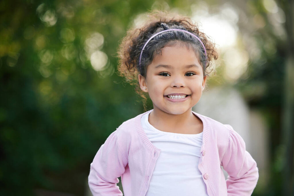 Childhood is a short season. Portrait of an adorable little girl having fun outdoors - Фото, зображення