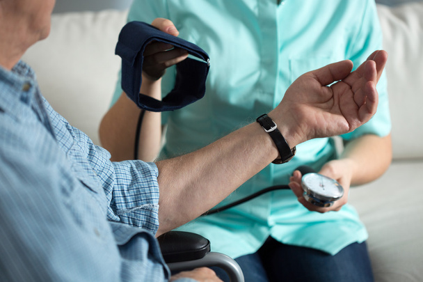 Nurse measuring blood pressure - Фото, изображение