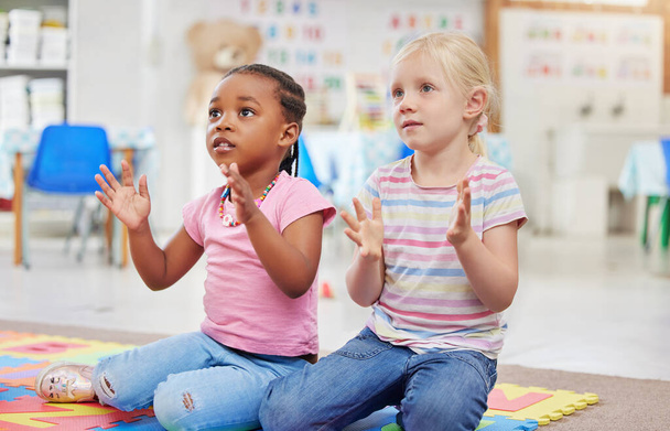 two little girls sitting next to each other in class. - Photo, image