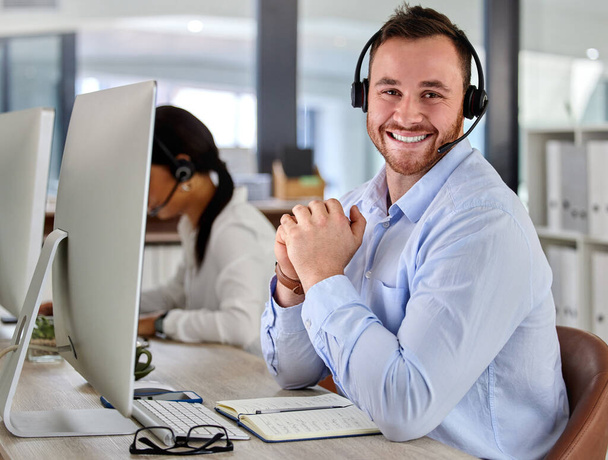 Making people smile every day. a young businessman working in a call center - Photo, image