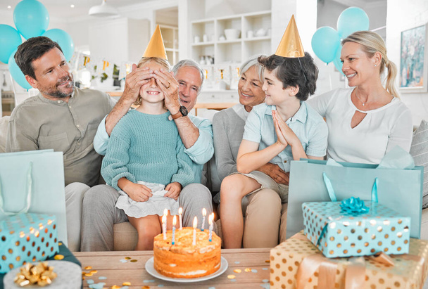 a happy family celebrating a birthday together at home. - Фото, зображення