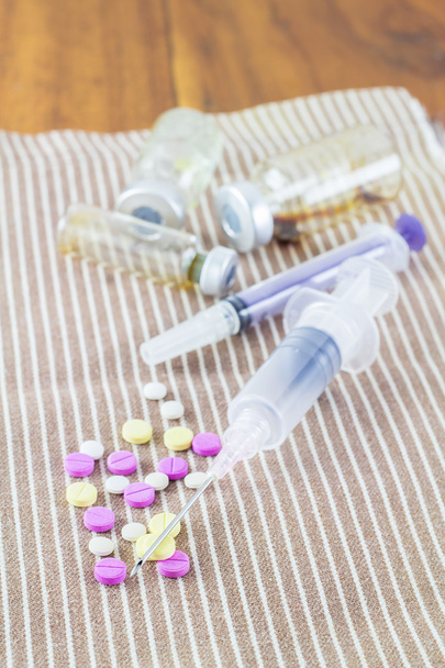 Different pills and syringe with needle - Photo, Image