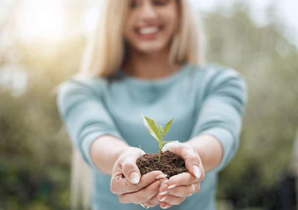 To new beginnings. a unrecognisable person holding a plant growing out of soil - Photo, image