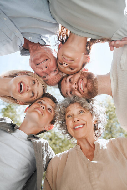 Nothing is more important than family. a multi-generational family standing together in a huddle - Foto, imagen