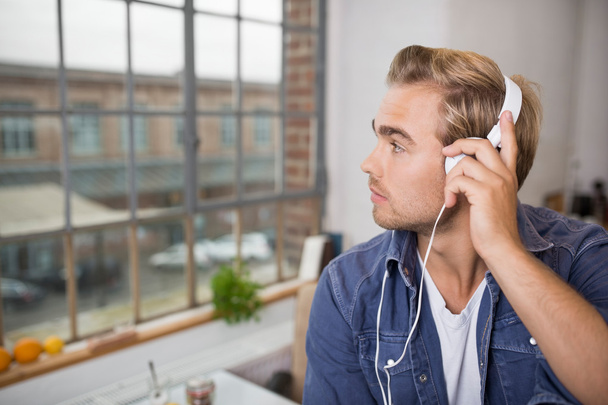 Man listening to music on headphones - Фото, зображення