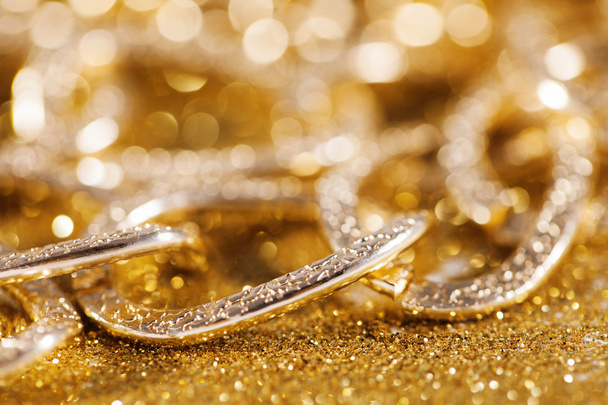 close up of golden chainlet. gold luxury jewelery. luxe glitter background - 写真・画像