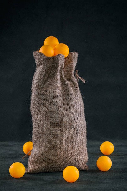 Still life with a full bag of orange balls - Photo, Image