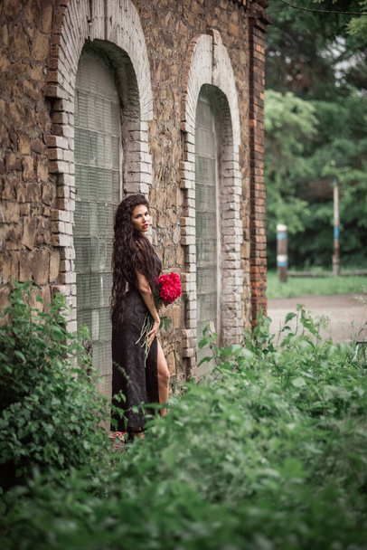 beautiful young woman in a gothic style with a red dress in the park - Fotografie, Obrázek