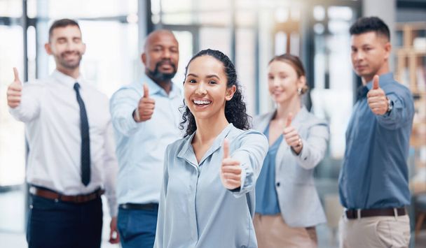 Youre our number one client. a group of businesspeople showing a thumbs up in an office at work - Фото, изображение