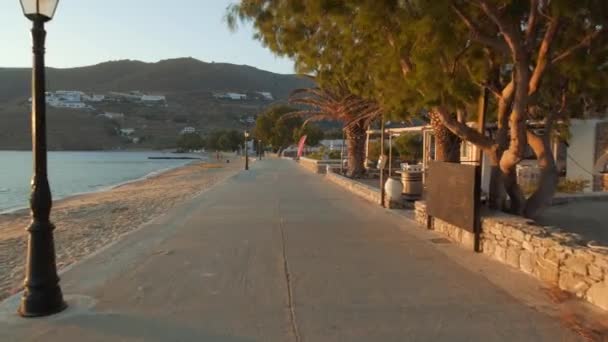 Beautiful promenade at sunset by the sea in the bay of the small typical village of Egliali on the island of Amorgos in Greece - Imágenes, Vídeo