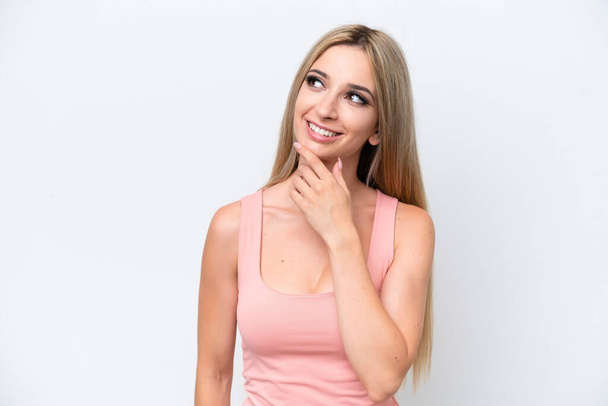 Pretty blonde woman isolated on white background looking up while smiling - Φωτογραφία, εικόνα