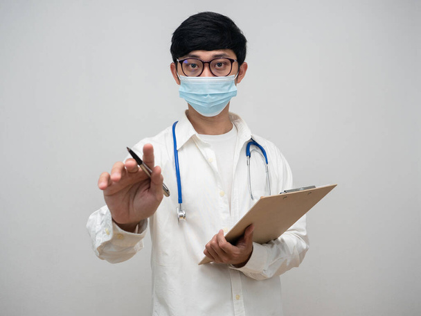 Doctor wearing medical mask hold wood board point finger at you - Fotoğraf, Görsel