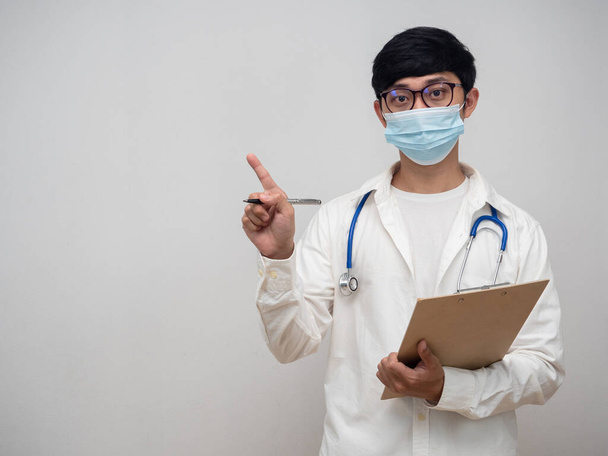Doctor wearing mask hold check list point finger at copy space - Photo, Image