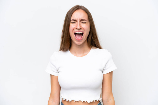 Young caucasian woman isolated on white background shouting to the front with mouth wide open - Φωτογραφία, εικόνα