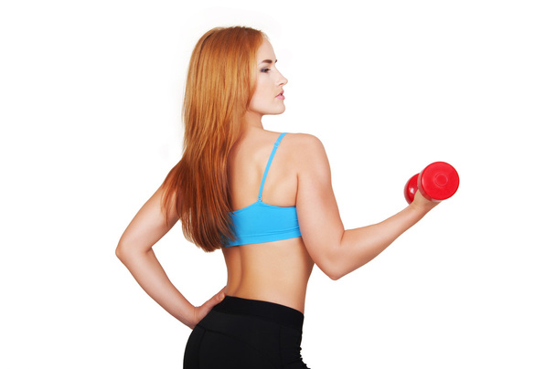 Young fit woman lifting dumbbells on white background - Foto, Bild