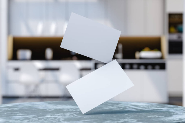 White mock up business cards hanging above table in light modern kitchen with appliances on blurred background in apartment. 3d render - Φωτογραφία, εικόνα