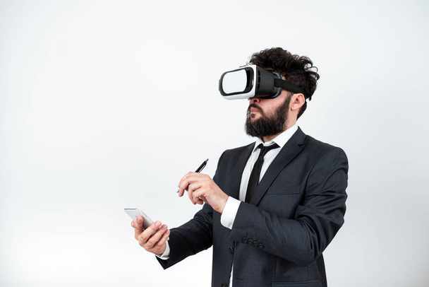 Man Holding Mobile Phone, Wearing Vr Glasses And Pointing On New Idea. - Foto, afbeelding