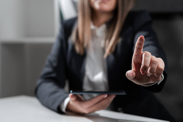 Woman Holding Tablet And Pointing With One Finger On Important Idea. - Photo, image