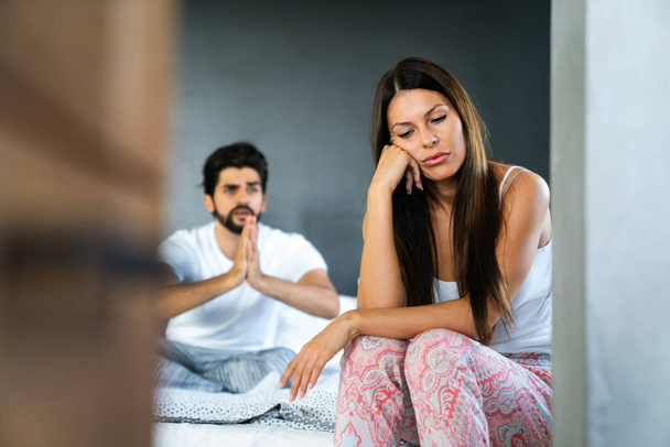 Couple having arguments and sexual problems in bed. Quarrel people concept - Valokuva, kuva