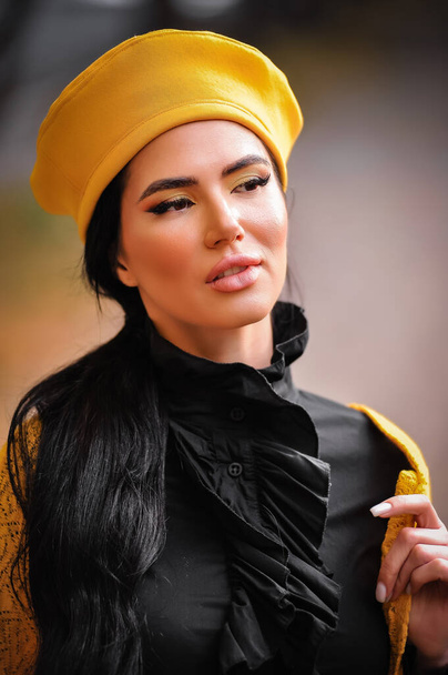 schöne junge Frau mit Dreadlocks, gelbem Turban und Schal auf einer Straße - Foto, Bild