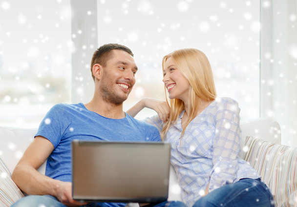 smiling happy couple with laptop at home - Fotografie, Obrázek