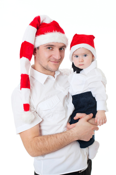 Happy cute family father and son in santa's hats - 写真・画像