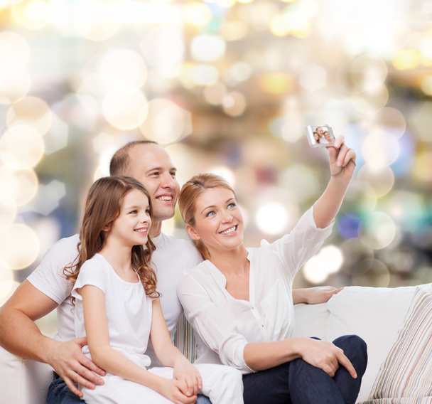happy family with camera at home - Foto, Bild
