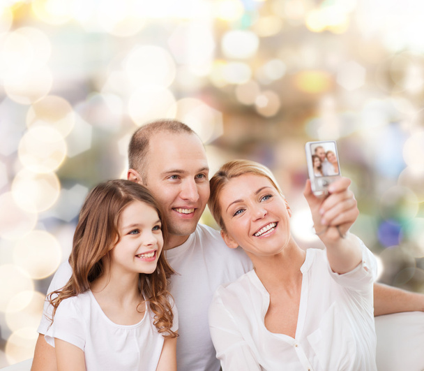happy family with camera at home - Zdjęcie, obraz