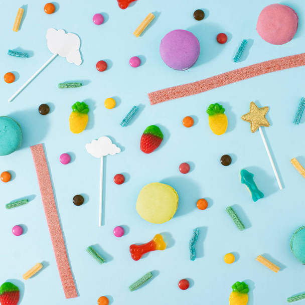 Creative Halloween concept many sweets for children in one place, a delicious junk snack. Flat lay, pastel blue background. - Foto, immagini