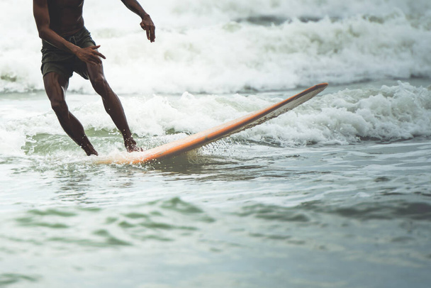 Blurred soft images of people are playing surfboard in the sea, a sport that requires strength and good balance, to people sport extreme concept. - Photo, image