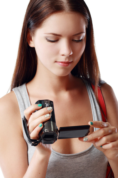 Woman looking at videocamera - Foto, afbeelding