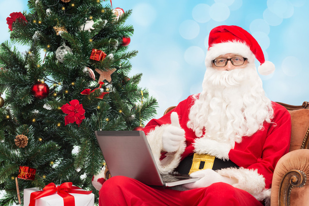 man in costume of santa claus with laptop - Photo, Image