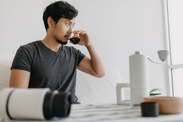 Asian man make and drink his own french press coffee. - Fotoğraf, Görsel