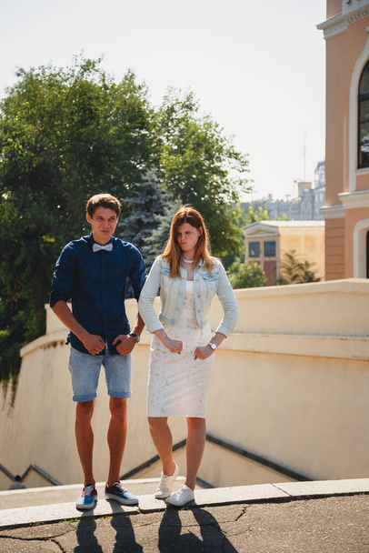 Cute young beautiful hipster couple is kidding, happy smiling outdoor portrait. - 写真・画像