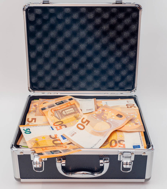 The suitcase is full of euro banknotes. Concept Investments, bribes, corruption. - Foto, Bild