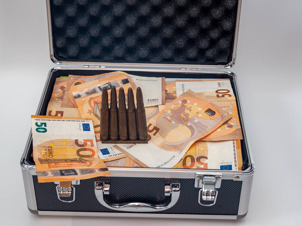 Bullet and euro money lie in a suitcase, armament money concept. - Foto, Imagem