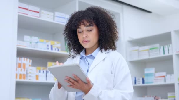 Portrait of a friendly pharmacist checking online precsciptions and orders on digital tablet. Face of a qualified chemist woman using pharma app to update stock system and inventory in a pharmacy. - Video