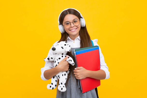 Schoolchild, teenage student girl with toy on isolated studio background. School and education concept. Back to school. Happy girl, positive and smiling emotions - Foto, Imagem