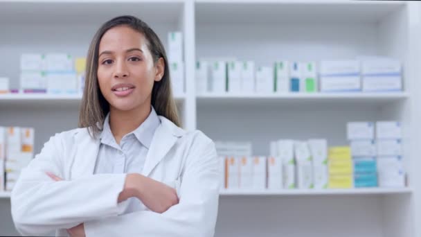 Professional pharmaceutical healthcare worker waiting to diagnose and prescribe pills in a drugstore. Portrait of a chemist with crossed arms against a background of prescription medication - Felvétel, videó