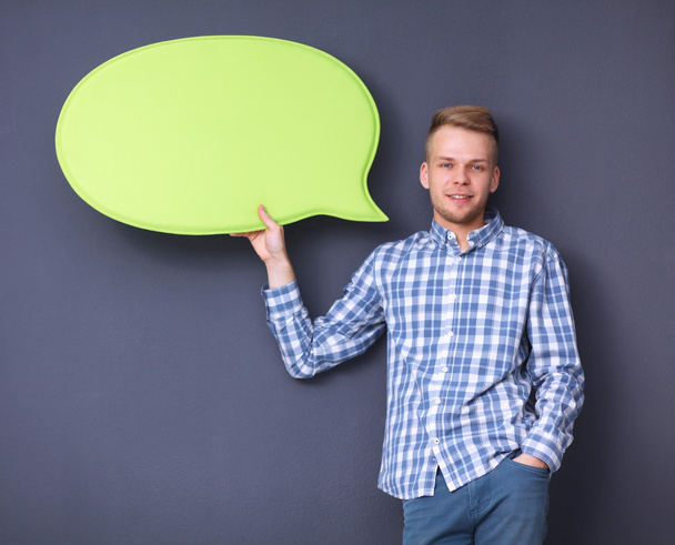 Man holding white blank speech bubble with space for text, isolated - Foto, afbeelding