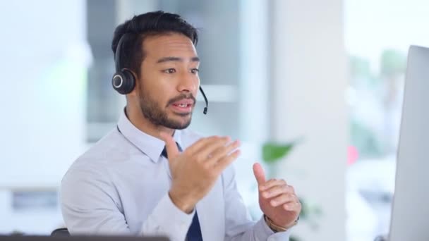 Call center agent consulting a buyer via video call in an office. A young friendly sales man talking to a client in a virtual meeting. A male customer service employee advising a consumer. - Záběry, video