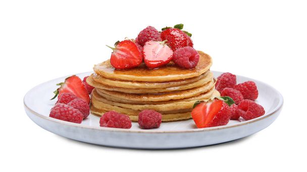 Tasty pancakes with fresh berries and honey on white background - Photo, image