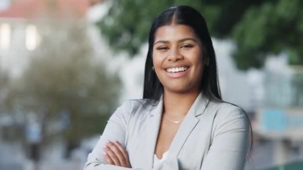 Corporate worker looking confident with her teeth whitening result. Face of a young and proud business woman with a big smile expression and arms crossed standing outside in a park or city garden. - Séquence, vidéo
